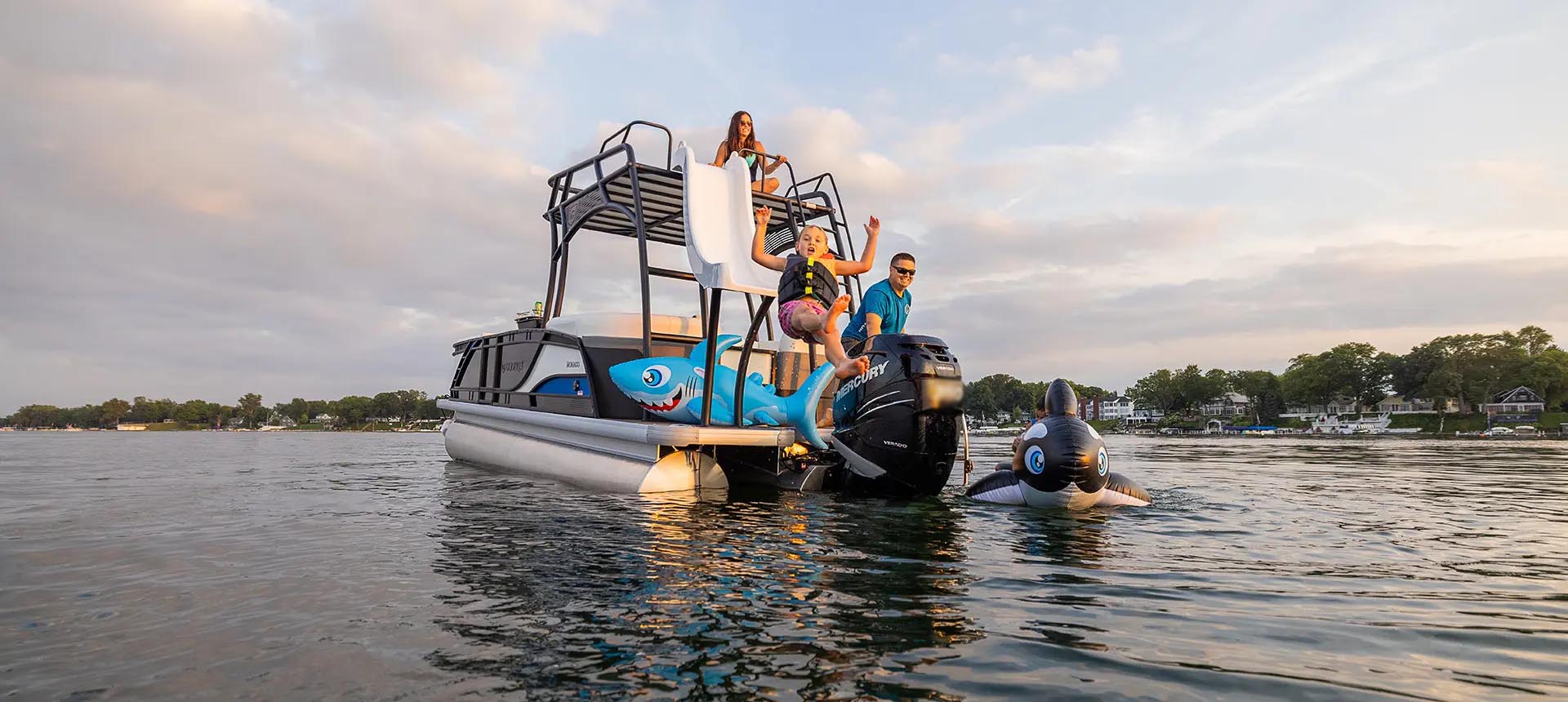 A pontoon with an upper deck and water slide