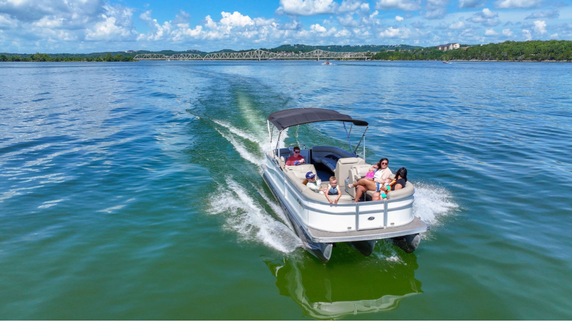 A family cruising Table Rock Lake in a pontoon boat